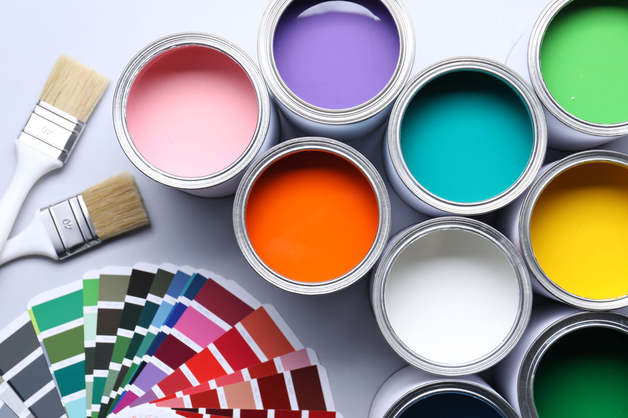 Cans of bright paints, brushes and color palettes on grey background, flat lay; Shutterstock ID 2603051265; purchase_order: CORP; job: Turkey Landing Page; client: ; other: 