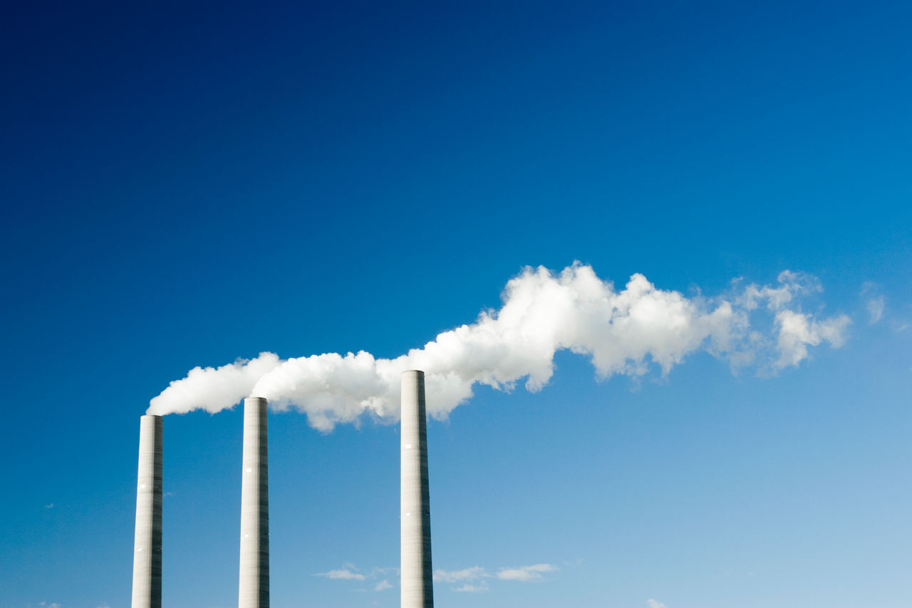 Smoke stacks on blue sky