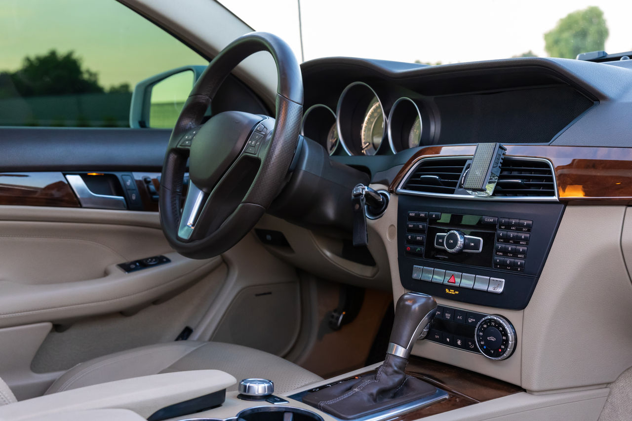 Elegant car interior with a sophisticated dashboard, plush seats, and stylish design elements