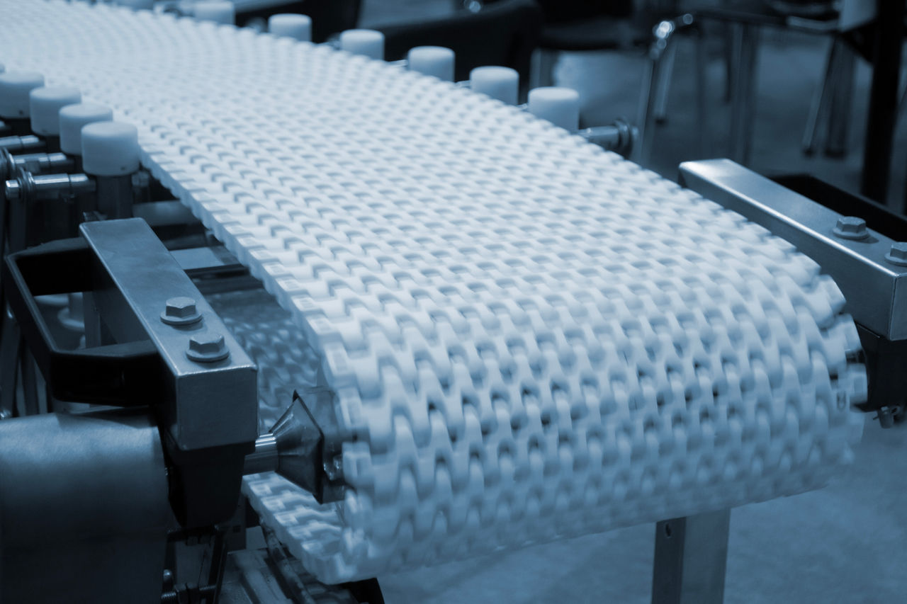 Modular belt rotary conveyor. Continuous movement system. Transportation of materials or products. Conveyors for moving objects. Production manufacture. Moving industrial belt. Connected plastic links; Shutterstock ID 2718378027; purchase_order: OPP Website & Media; job: ; client: ; other: 
