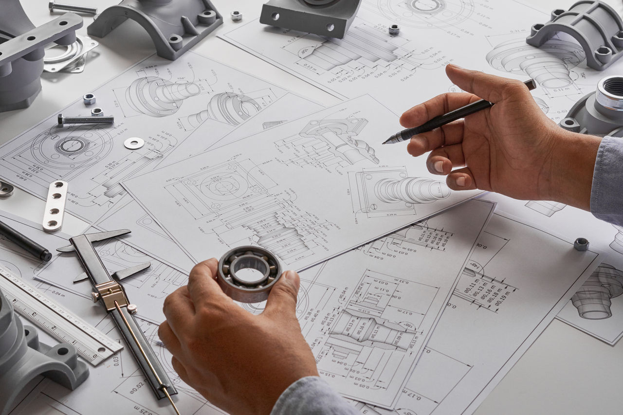 Engineer technician designing drawings mechanical parts engineering Engine