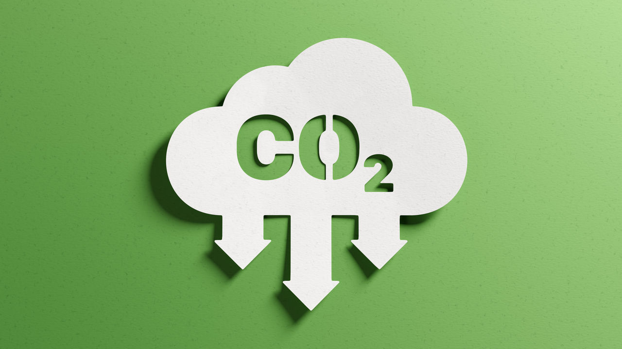 Reduce CO2 emissions to limit climate change and global warming. Low greenhouse gas levels, decarbonize, net zero carbon dioxide footprint. Abstract minimalist design, cutout paper, green background.; Shutterstock ID 2156662655; purchase_order: CON; job: CO2 reduction; client: CON; other: CON