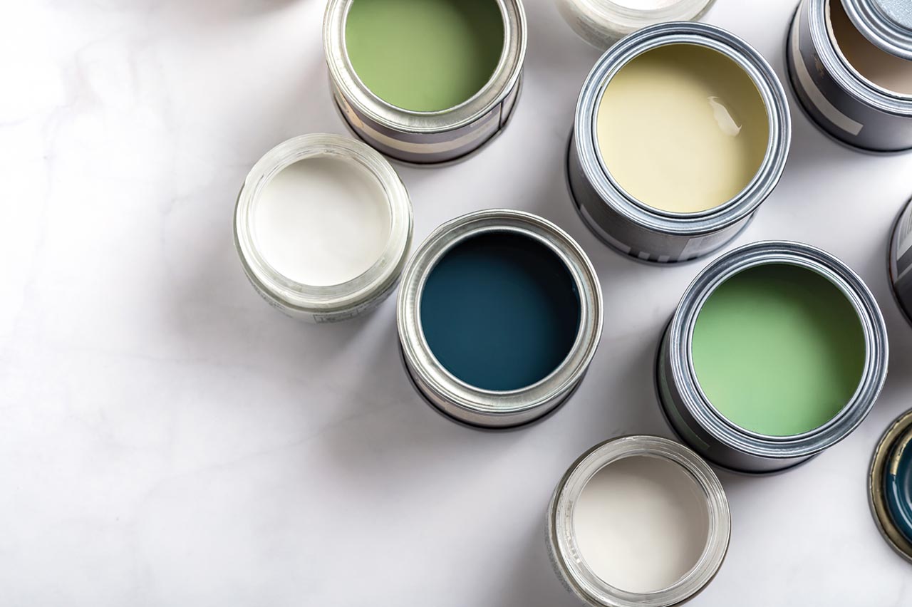 Paint cans during house renovation, process of choosing paint for the walls, different green and beige colors, color charts on background;; purchase_order: CON; job: SUS Toolkit brochure; client: ; other: 