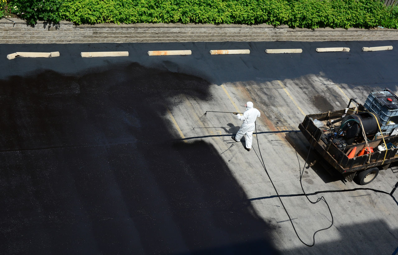 person sealing a parking lot